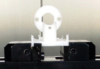 The low clamping force needed to hold parts with the PositiveLock system allows thin and flexible materials to be held. In this application, a block of Teflon is machined to produce the part.
